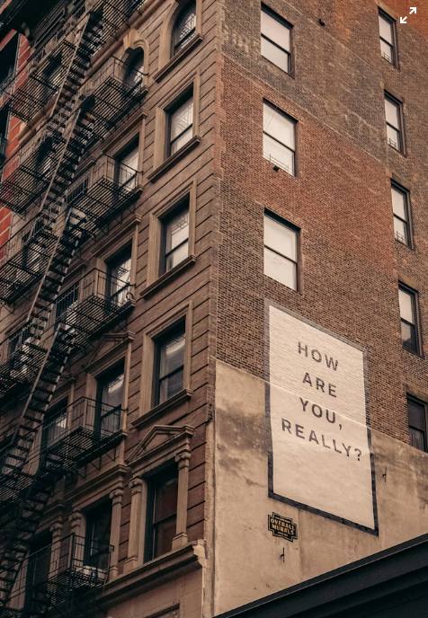NYC brownstone mural reading 'How Are You, Really?' — a community reminder that asking for support matters