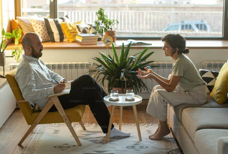 Natural light therapy session — two people in a comfortable living room setting at Safe Vision Family Programs